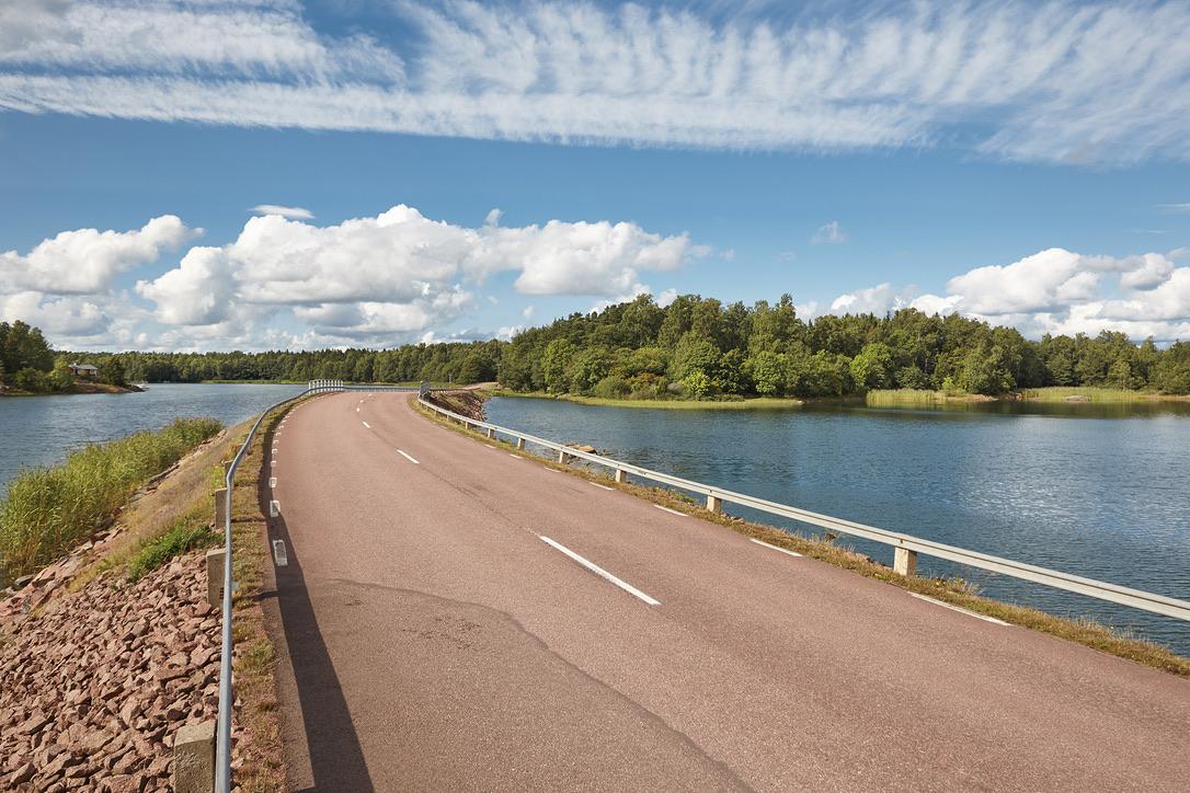 Finnish landscape with road, lake and forest island. Finland. Europe